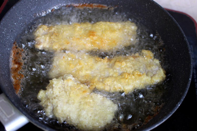 Bước 3: Đặt chảo dầu lên bếp, đợi dầu nóng rồi thả từng miếng thịt vào chiên cho đến khi thấy chúng chín vàng giòn thì vớt ra đĩa.