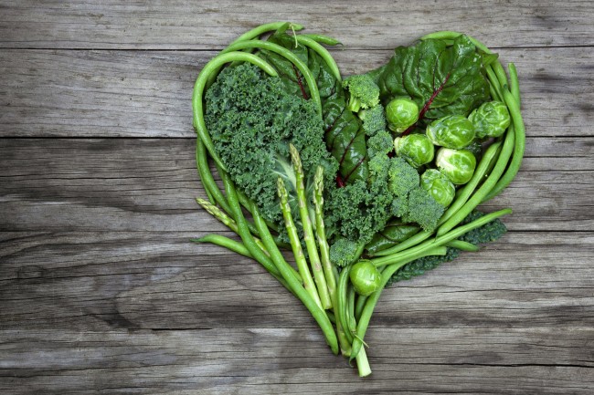 Vegetables - Green Heart Shape on Wood background