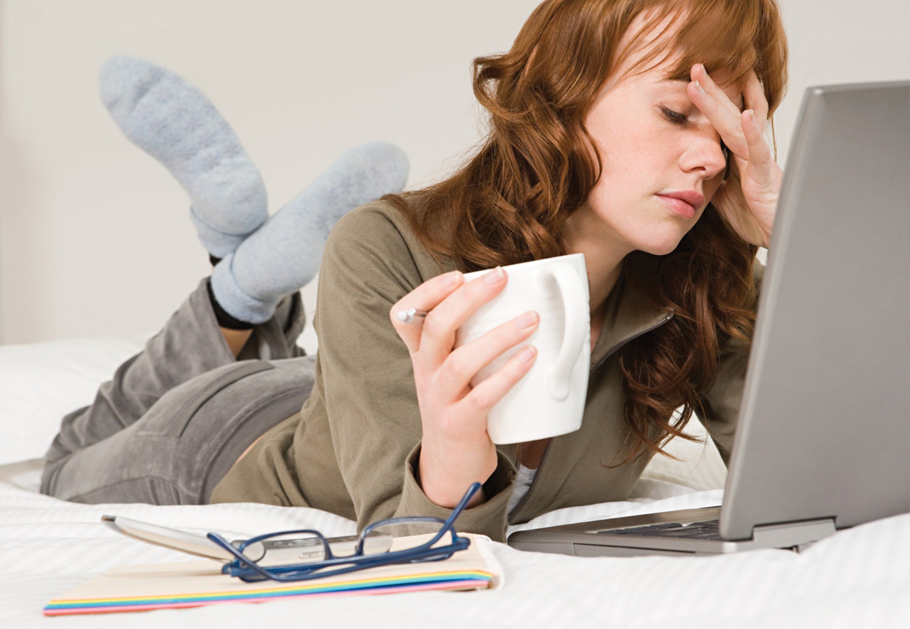 A stressed woman working on a laptop