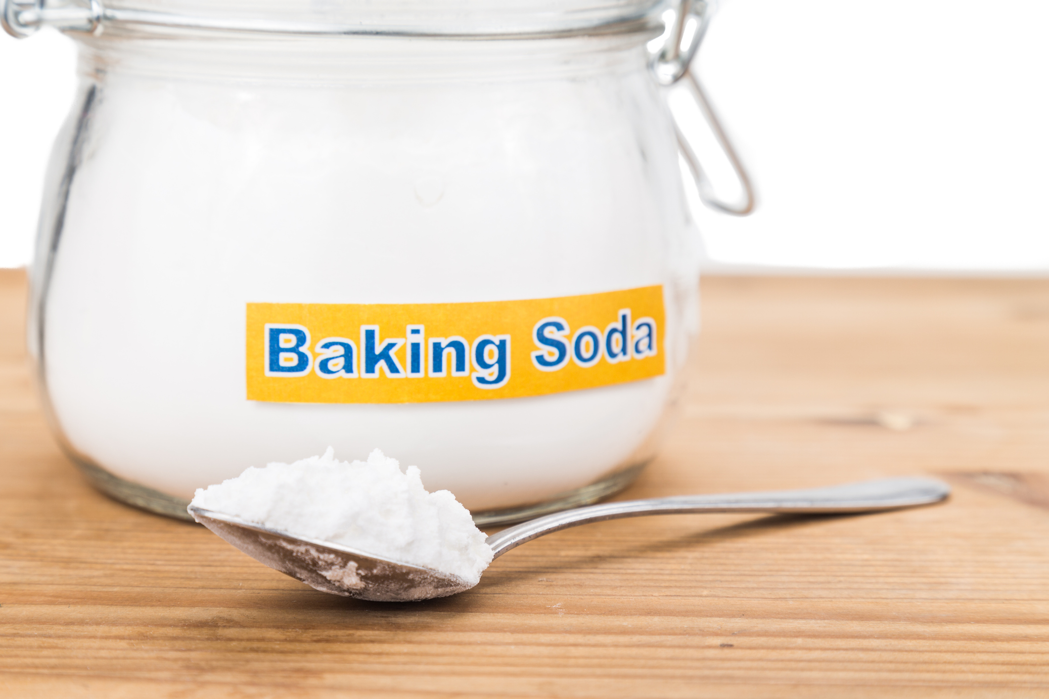 Jar and spoonful of baking soda for multiple holistic usages