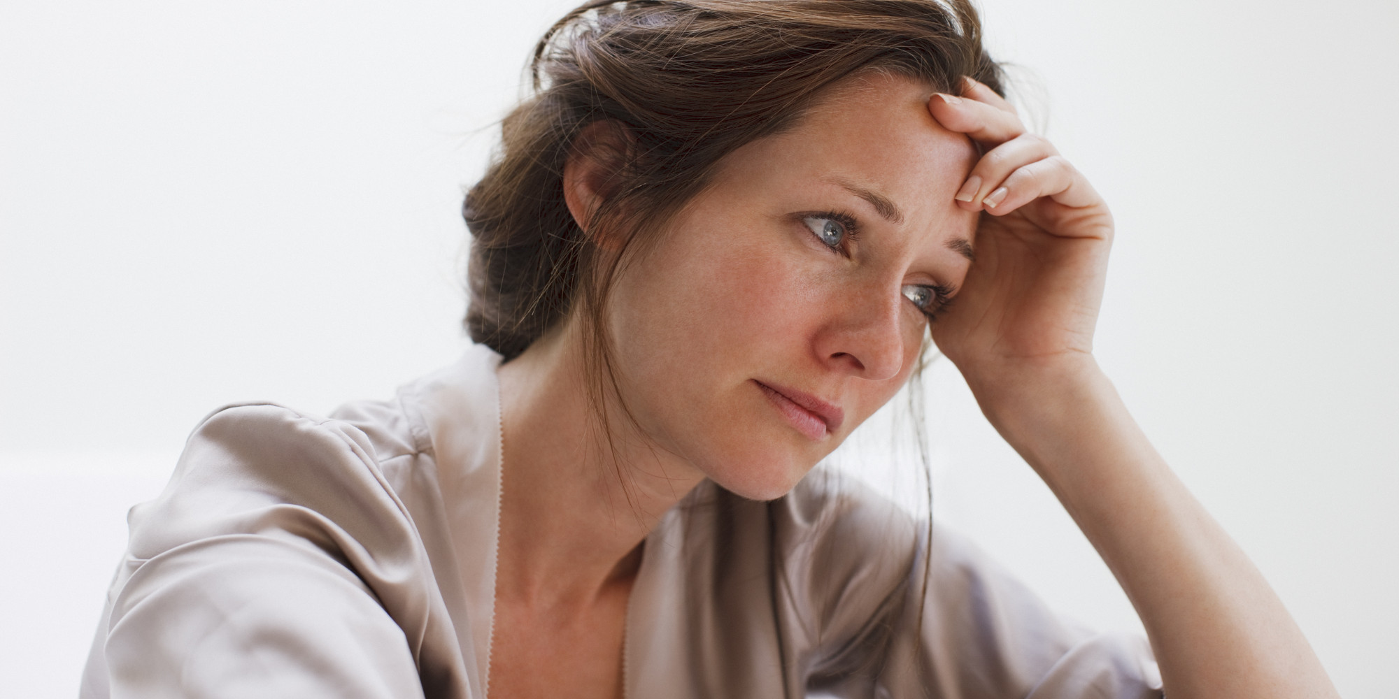 Depressed woman with head in hands