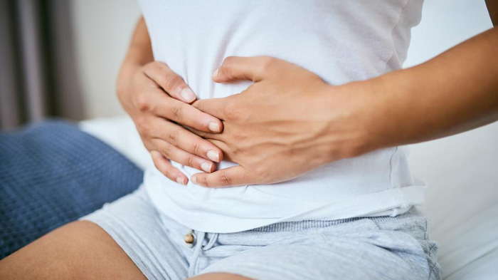 a-woman-holding-her-stomach-because-she-is-experiencing-constipation-because-of-ulcerative-colitis-16033635643421940698250