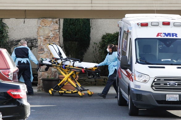 A stretcher is moved from an AMR ambulance to the Life Care Center of Kirkland where one associate and one resident were diagnosed with the novel coronavirus (COVID-19) according to a statement released by the facility in Kirkland, Washington on February 29, 2020. - The first fatality from the novel coronavirus has been confirmed on US soil, as President Donald Trump on Saturday urged Americans not to panic. (Photo by Jason Redmond / AFP) (Photo by JASON REDMOND/AFP via Getty Images)